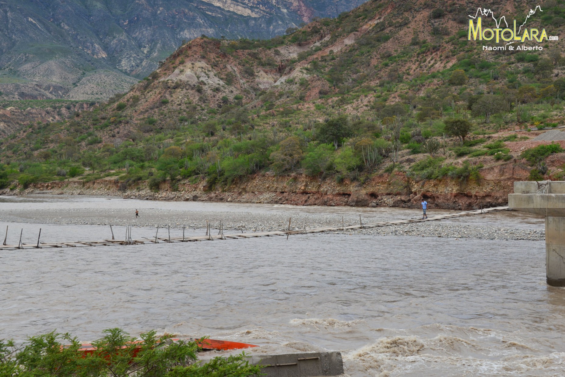 Pablo walking on the swinging bridge. Yonan running upstream for a swim.