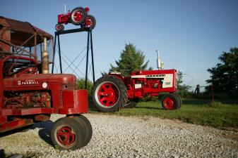 tractor parked under the farmall-land sign