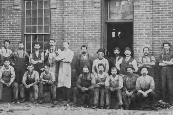 group in front of charter engine co.