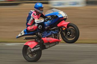 Andrew Stroud doing a wheelie on a John Britten